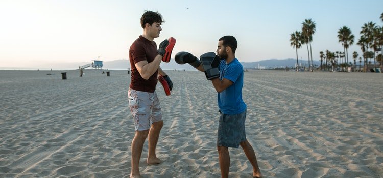 One-on-one workout at the beach, representing how to become a personal trainer in Dubai